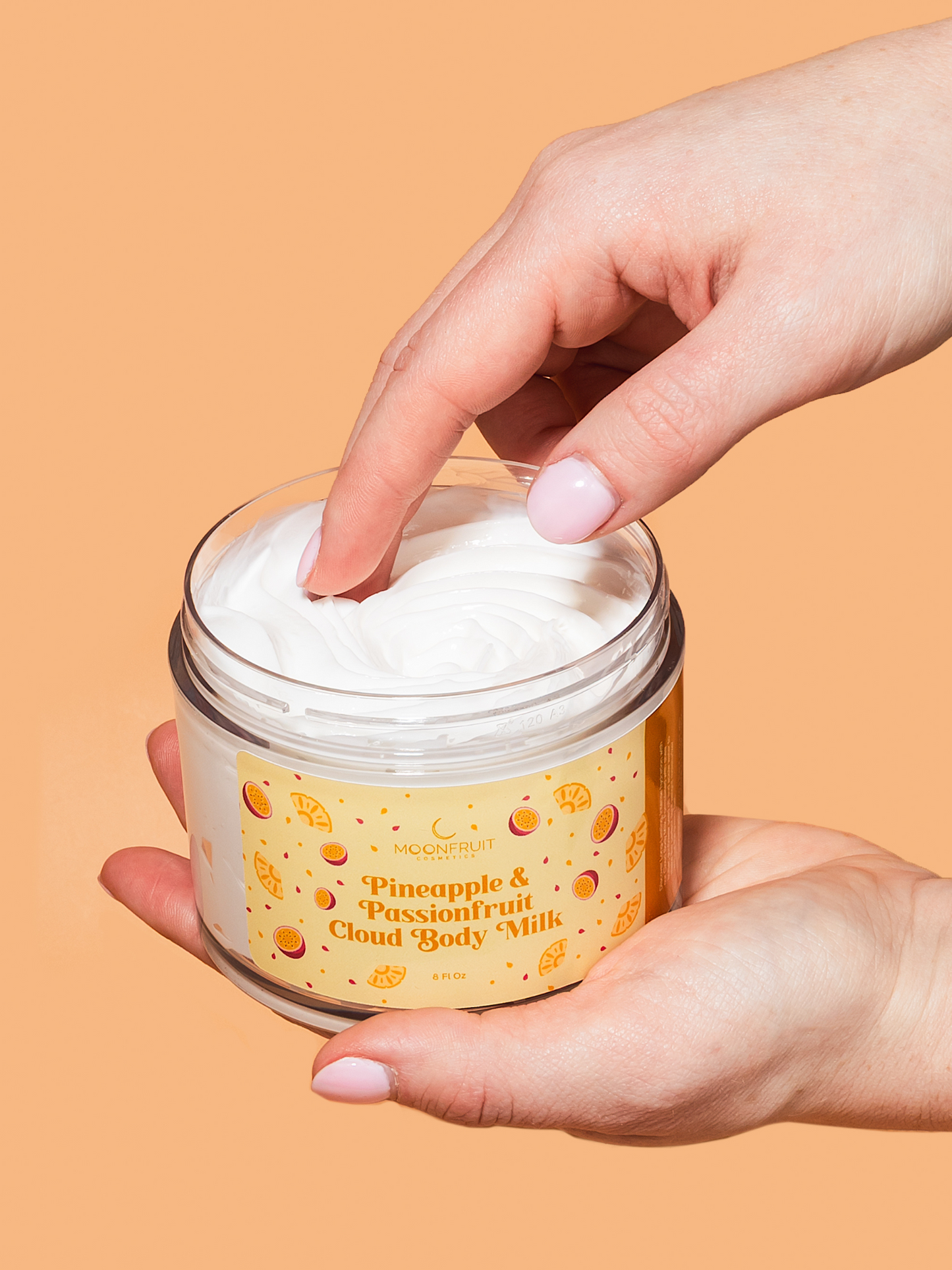 Hydrating Pineapple passionfruit Cloud Body Milk by MoonFruit Cosmetics – luxurious, lightweight body moisturizer in a whipped cream texture. Made with shea butter, mango butter, sunflower seed oil, ideal for hydrating and nourishing dry skin. Product styled with tropical elements for a clean, natural skincare appeal